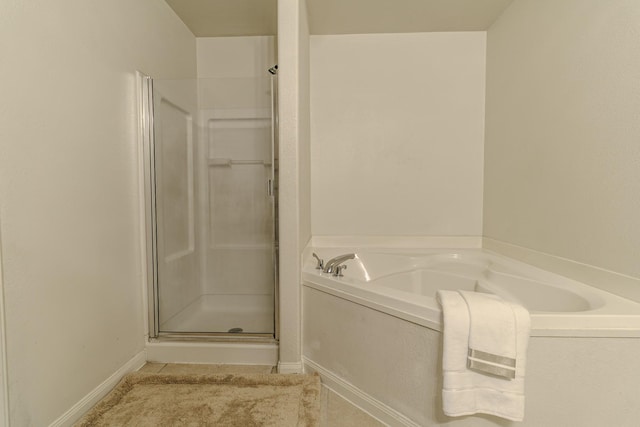 bathroom featuring shower with separate bathtub and tile patterned floors