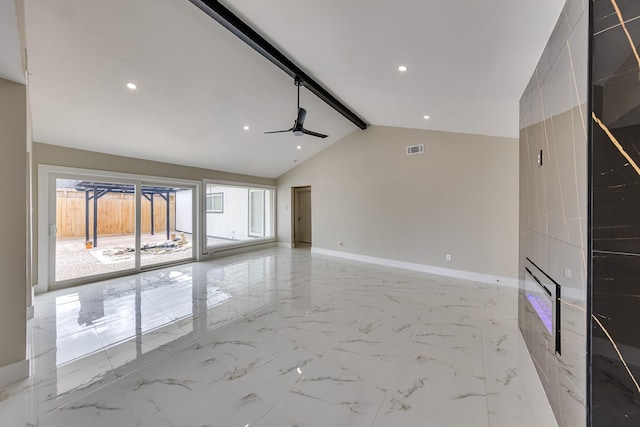 empty room featuring vaulted ceiling with beams and ceiling fan