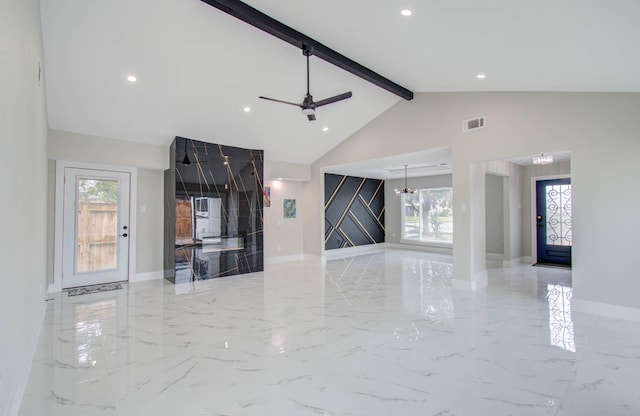 unfurnished living room with beamed ceiling, ceiling fan with notable chandelier, high vaulted ceiling, and plenty of natural light