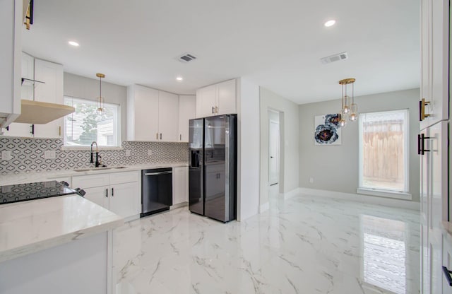 kitchen with white cabinetry, sink, light stone counters, and appliances with stainless steel finishes