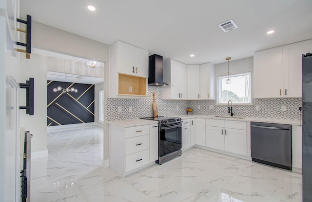 kitchen with backsplash, white cabinets, wall chimney exhaust hood, decorative light fixtures, and stainless steel appliances