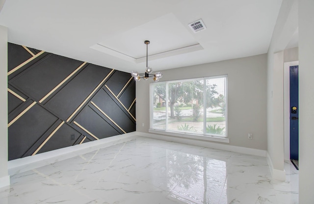 unfurnished room with a chandelier