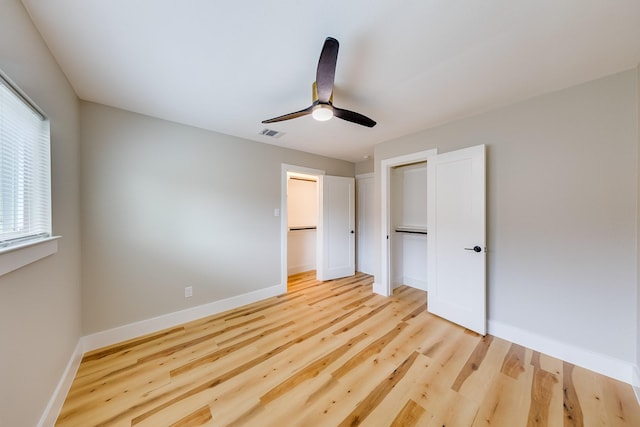 unfurnished bedroom featuring ceiling fan, a closet, and light hardwood / wood-style flooring