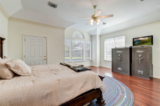 bedroom featuring dark hardwood / wood-style flooring, ceiling fan, and crown molding