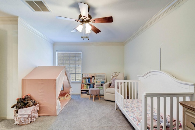 bedroom featuring ceiling fan, ornamental molding, a nursery area, and light carpet