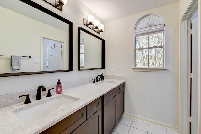 bathroom with tile patterned flooring, a textured ceiling, and vanity