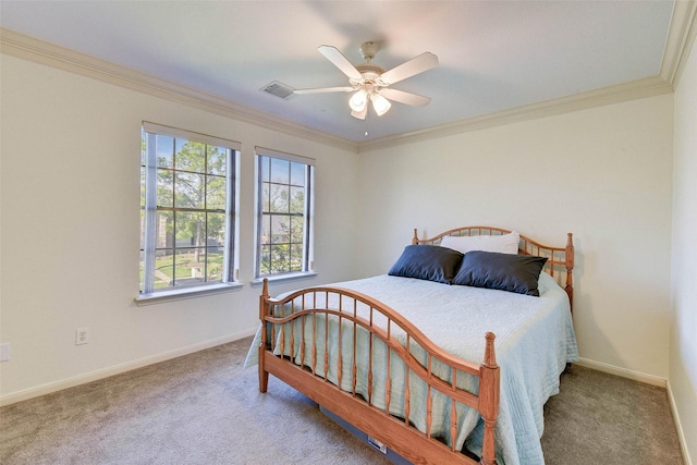 carpeted bedroom featuring ceiling fan and crown molding