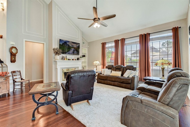 living room with ceiling fan, high vaulted ceiling, and hardwood / wood-style flooring