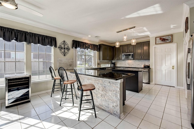 kitchen with a kitchen breakfast bar, crown molding, light tile patterned floors, pendant lighting, and a kitchen island