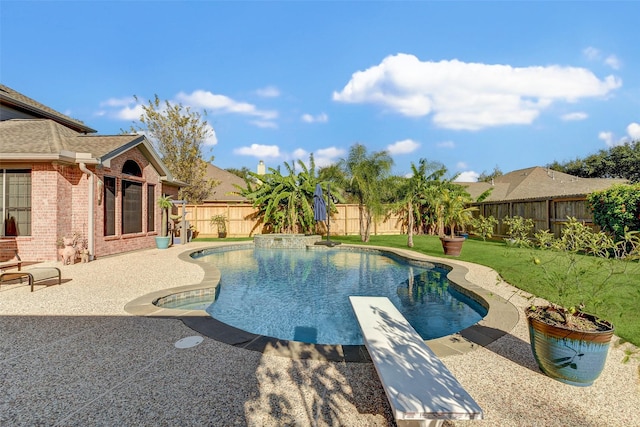 view of swimming pool with a yard, a diving board, and a patio area