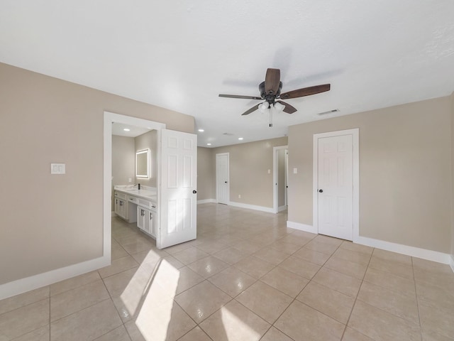 empty room featuring ceiling fan and light tile patterned floors