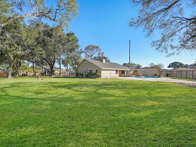 view of yard with a fenced in pool and a patio area