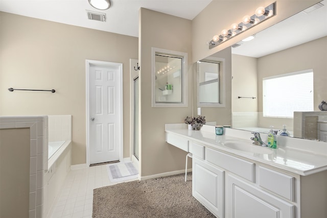 bathroom featuring shower with separate bathtub and vanity