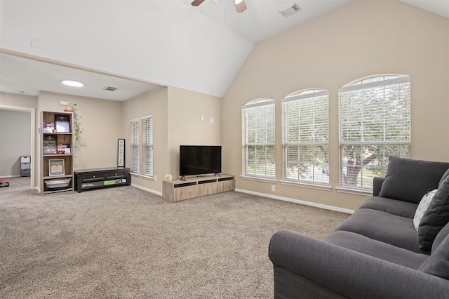 carpeted living room featuring ceiling fan and vaulted ceiling