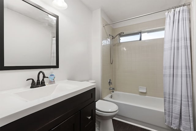 full bathroom with hardwood / wood-style floors, shower / bath combo, toilet, and vanity