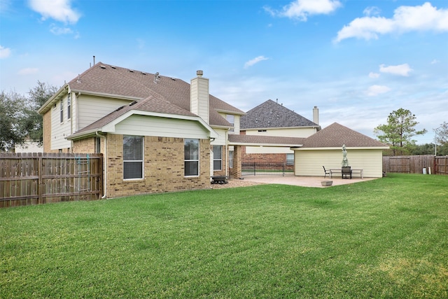 back of house with a yard and a patio