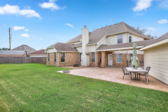 rear view of house featuring a yard and a patio area