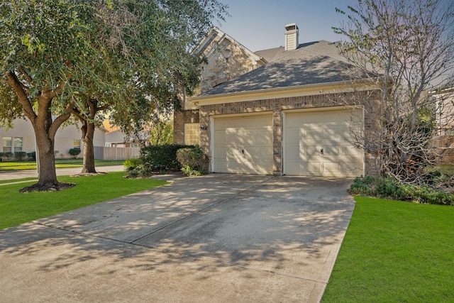 view of front of property featuring a garage and a front lawn