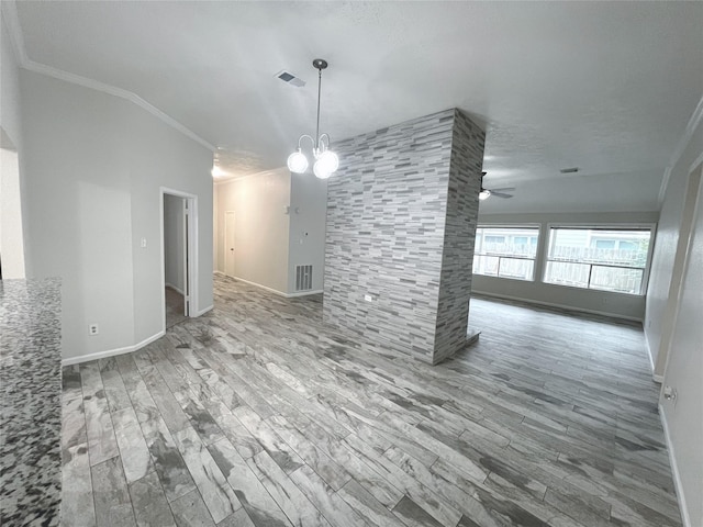 unfurnished dining area featuring hardwood / wood-style floors, ceiling fan with notable chandelier, ornamental molding, and vaulted ceiling