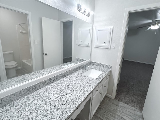 full bathroom with vanity, toilet, a textured ceiling, and bathtub / shower combination