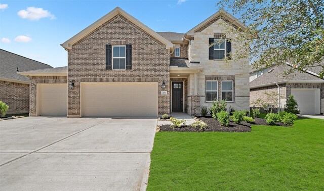 view of front facade with a front yard and a garage