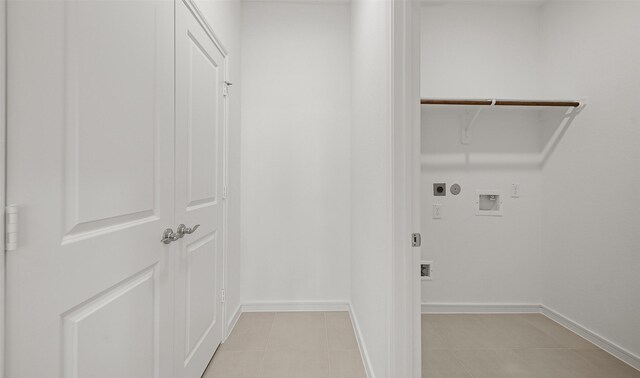 clothes washing area featuring hookup for an electric dryer, hookup for a washing machine, and light tile patterned floors