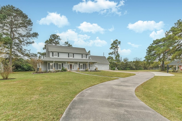 country-style home featuring a porch, a garage, and a front yard