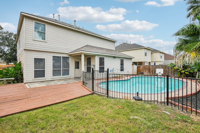 view of swimming pool with a wooden deck and a yard