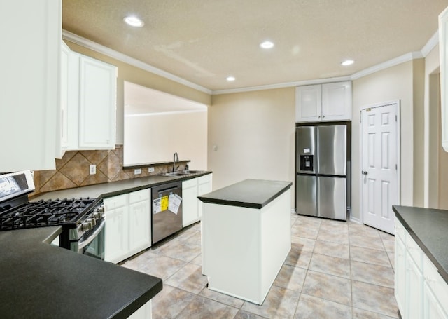 kitchen featuring sink, stainless steel appliances, a center island, white cabinets, and decorative backsplash