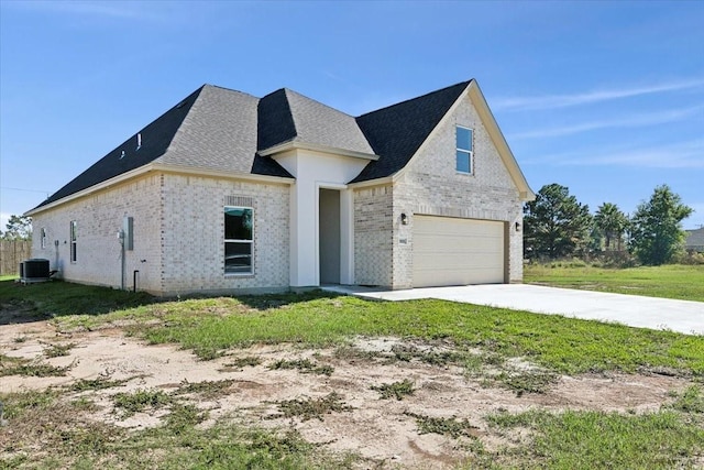 french country inspired facade featuring cooling unit and a garage