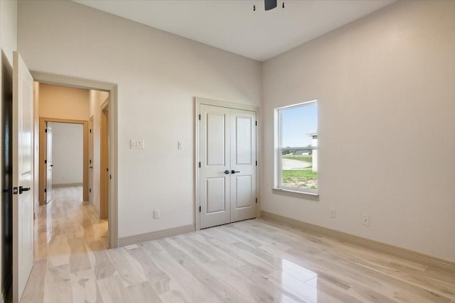 unfurnished bedroom featuring light hardwood / wood-style floors and a closet