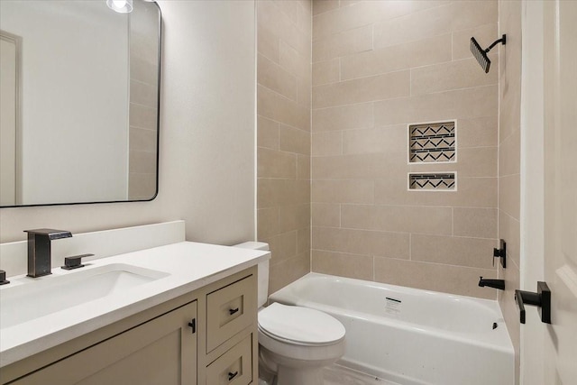 full bathroom with vanity, toilet, and tiled shower / bath