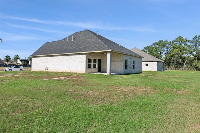 back of property with a lawn