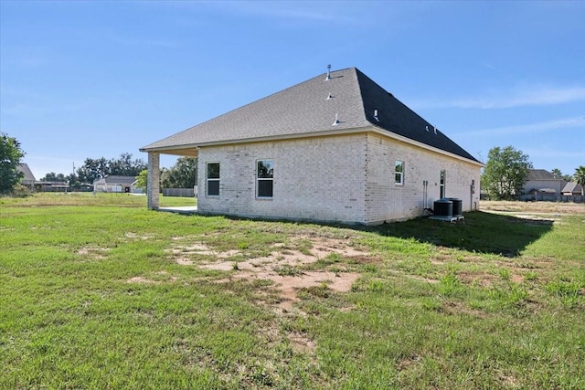 rear view of property featuring a lawn