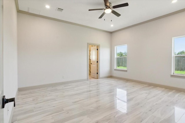 empty room with ceiling fan, ornamental molding, and light hardwood / wood-style flooring