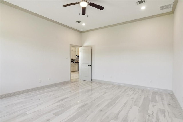 spare room featuring ceiling fan, light hardwood / wood-style flooring, and ornamental molding