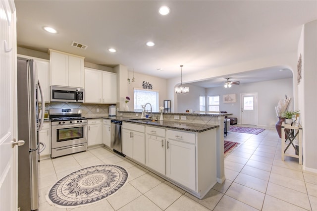 kitchen with white cabinets, sink, kitchen peninsula, and stainless steel appliances