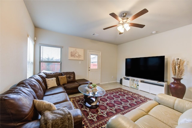 tiled living room featuring ceiling fan