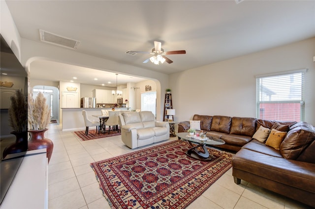 living room with ceiling fan and light tile patterned flooring