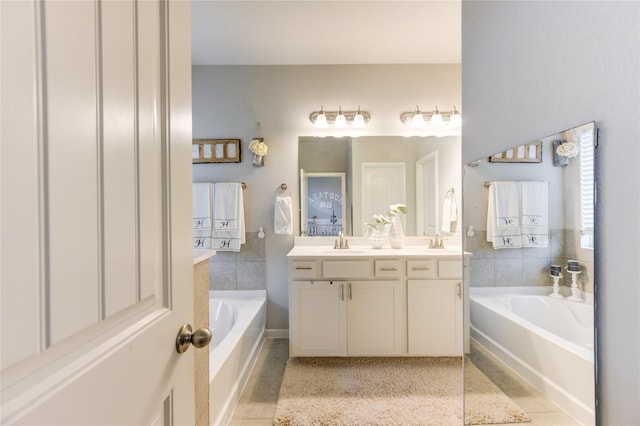 bathroom with tile patterned flooring, vanity, and a bathtub