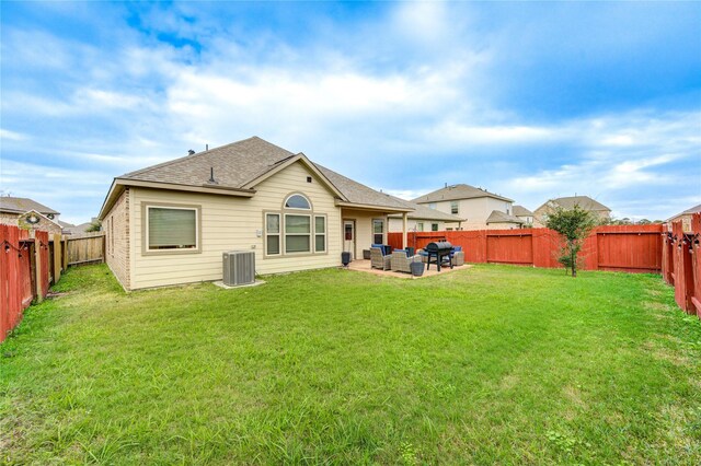 rear view of property featuring outdoor lounge area, a yard, a patio, and central AC unit