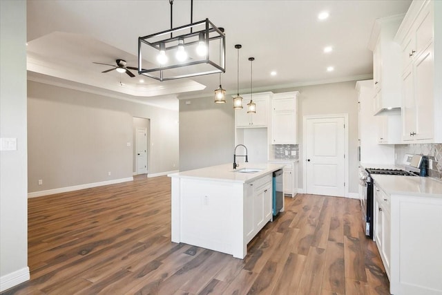 kitchen featuring sink, hanging light fixtures, a center island with sink, white cabinets, and appliances with stainless steel finishes