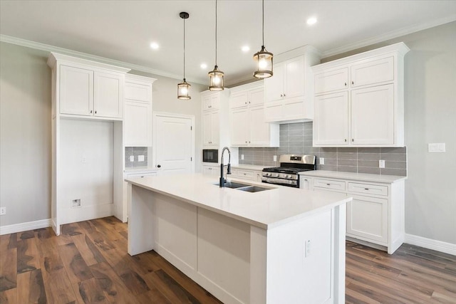 kitchen with gas range, pendant lighting, white cabinets, and dark wood-type flooring