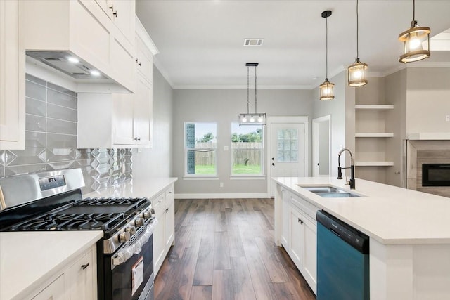 kitchen featuring appliances with stainless steel finishes, backsplash, decorative light fixtures, and dark hardwood / wood-style floors