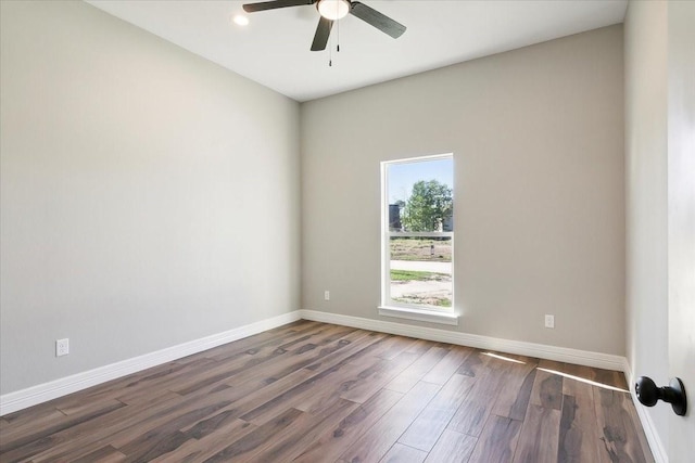 spare room with ceiling fan and dark wood-type flooring