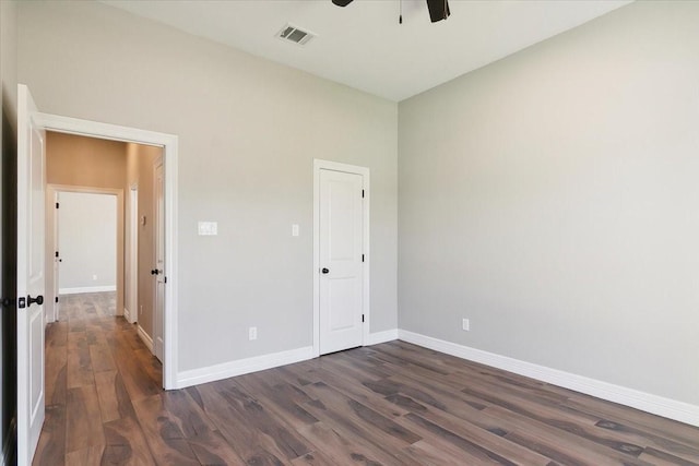 unfurnished bedroom featuring ceiling fan and dark hardwood / wood-style flooring