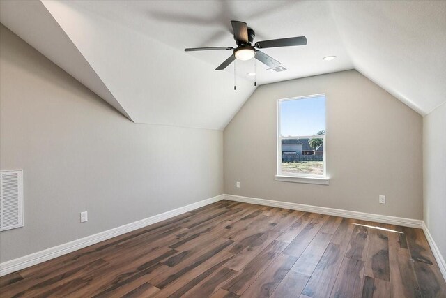 bonus room featuring ceiling fan, dark wood-type flooring, and vaulted ceiling