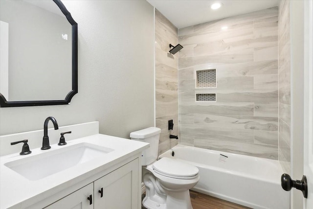 full bathroom with wood-type flooring, vanity, toilet, and tiled shower / bath