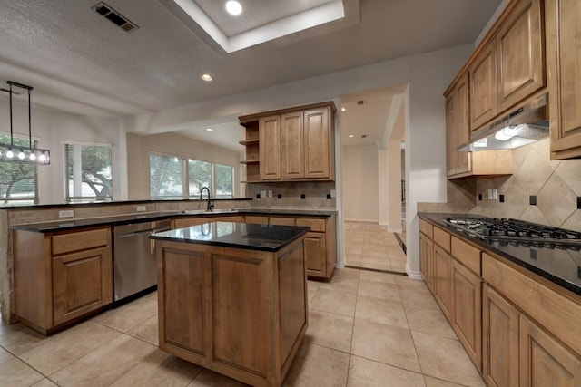 kitchen featuring pendant lighting, appliances with stainless steel finishes, a kitchen island, sink, and light tile patterned floors