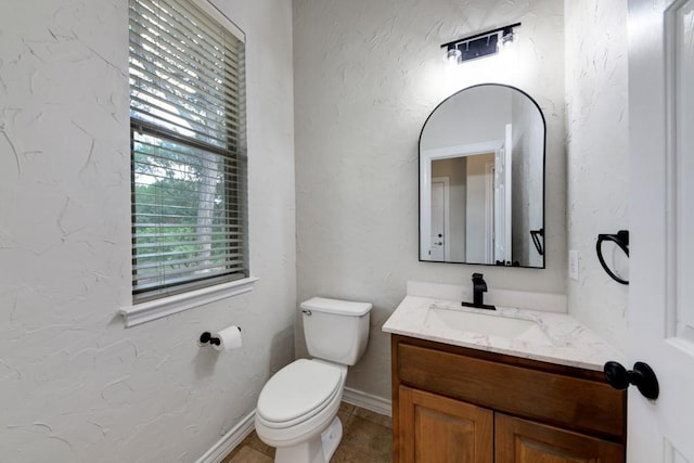 bathroom with toilet and vanity